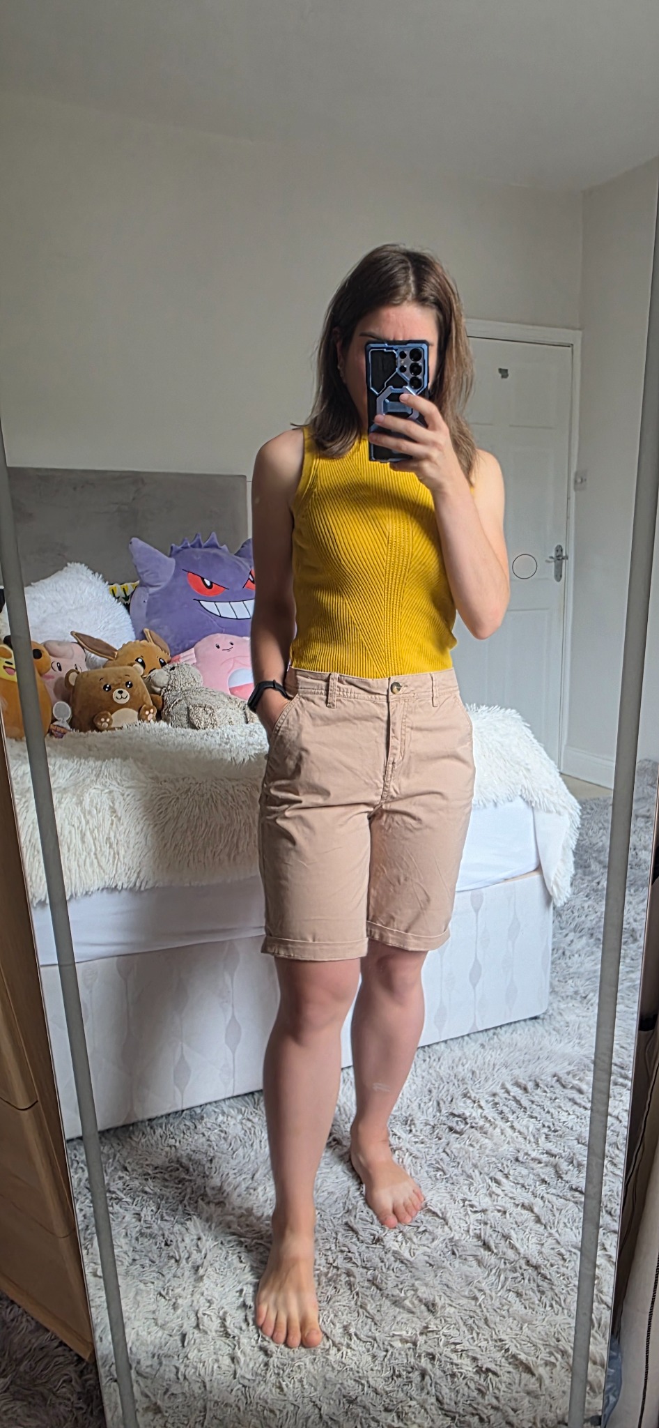 Beige Papaya chino shorts styled with a mustard sleeveless top